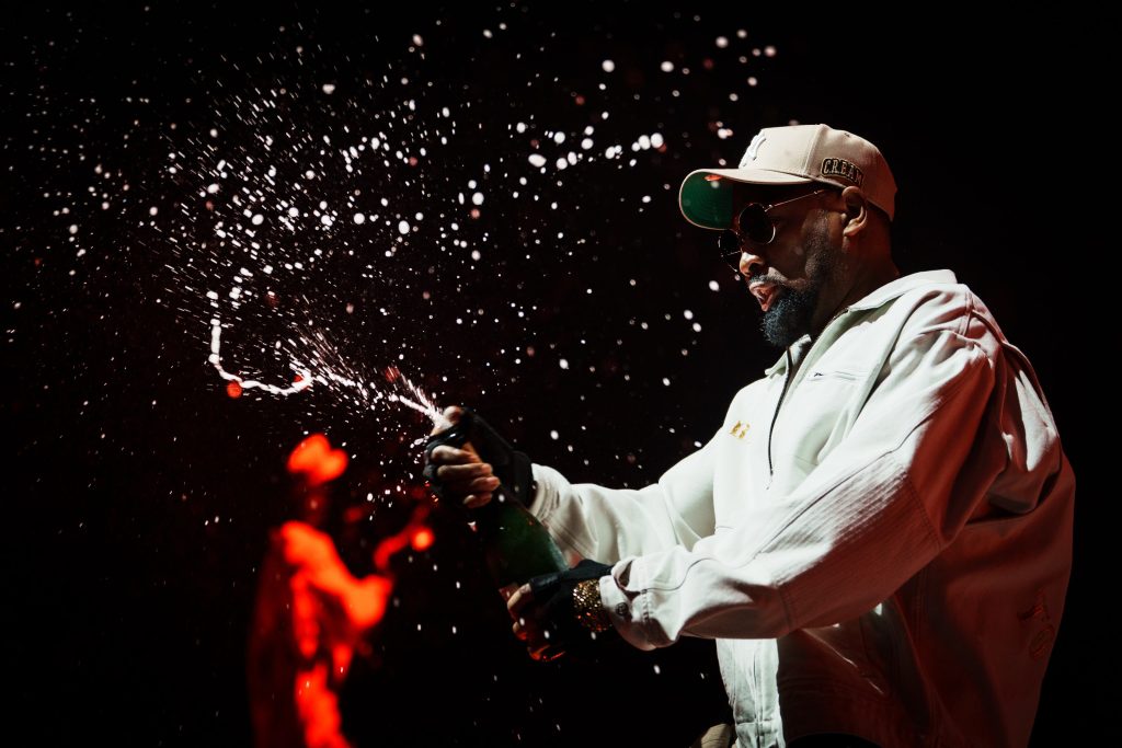 The Wu-Tang Clan opens a bottle of champagne on stage during their concert at the ING Arena